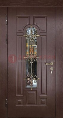 Темная железная дверь со стеклом и ковкой для частного дома ДСК-156 в Одинцово